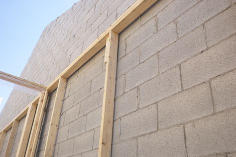 Framing out interior walls over cinder blocks can hide them. Hang Drywall, Cinder Block House, Basement Rooms, Concrete Block House, Drywall Finishing, Concrete Block Walls, Cinder Block Walls, Dream Basement, Window Trim Exterior