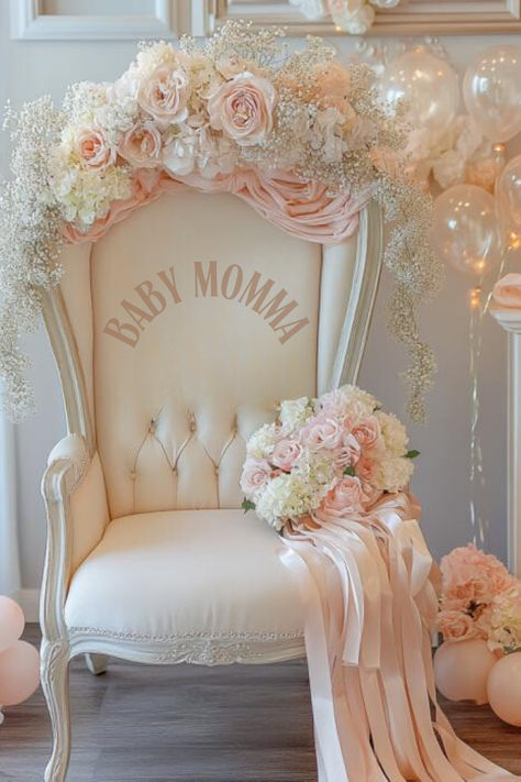 Baby shower chair with “Baby Momma” printed on the front inside, beautifully decorated with blush pink and white roses, baby's breath, and flowing ribbons. The chair is set against a backdrop of pastel balloons and soft florals, creating an elegant and luxurious feel for the mom-to-be’s special day. *We may earn a small commission from your purchase. Cream Baby Shower Decor, Baby Shower Chair For Mom, Princess Theme Baby Shower Ideas, Coquette Baby Shower Theme, Elegant Baby Shower Ideas, Vintage Baby Shower Ideas, Beige Balloons, Cream Balloons, Baby Shower Chair