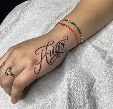 Hugo Tattoo Name, Ivan Name Tattoo, Hand Tattoos With Names, Name Tattoos On Women, Feminine Name Tattoos, Jose Name Tattoo, Hand Tattoo Name, Name Placement Tattoos, Name Tattoo Hand