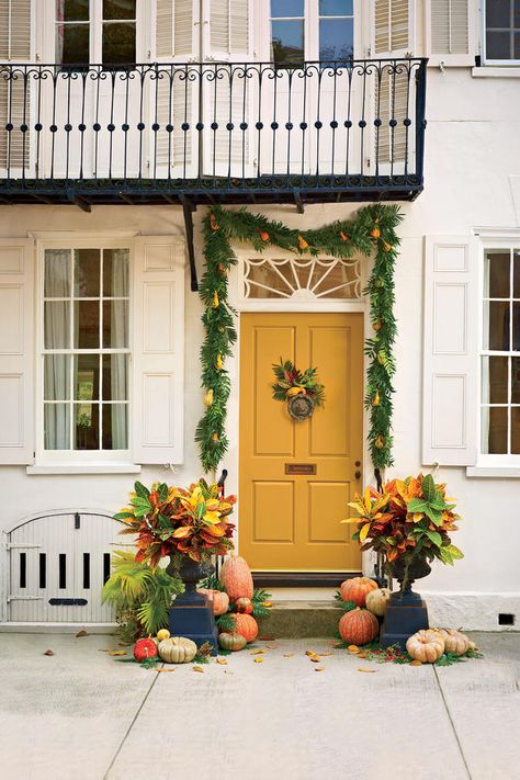 A door painted in a cheery marigold hue is so autumnal when paired with a scattering of pumpkins. Yellow Front Door, Creative Pumpkin Decorating, Yellow Front Doors, Fall Front Porch Ideas, Halloween Front Doors, Yellow Door, Creative Pumpkins, Fall Door Decorations, Fall Front Door