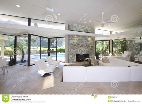 Seating Area And Stone Fireplace In Spacious Living Room With Pool ... Design Camino, All White Room, Sunken Living Room, Elegant Living Room Design, Open Concept Home, Design Del Prodotto, Elegant Living Room, White Rooms, Living Room Flooring