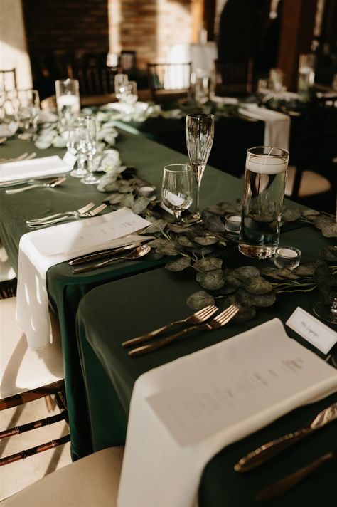 Layne and Francis celebrated a gorgeous winter wedding, which featured hunter green and ivory linens with gold accents ✨ Hunter Green Linens Wedding, Midnight Blue And Emerald Green Wedding, Green Ivory And Gold Winter Wedding, Hunter Green Table Cloth Wedding, Dark Green Table Cloth Wedding, Emerald Green Wedding Decorations Centerpieces Table Settings, Dark Green Wedding Table Settings, Wedding Green Tablecloth, Forest Green And Beige Wedding