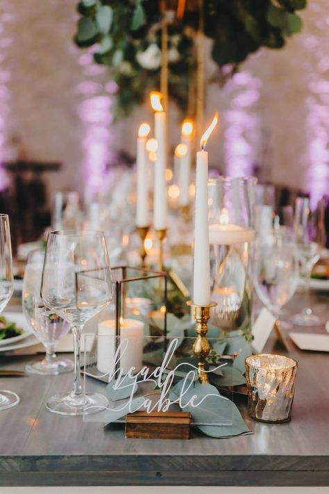 This outdoor wedding features lots of lush greenery with blue and white florals. Set in the Texas hill country with a garden vibe. Eucalyptus garland with mixed geo shapes, tall centerpieces, brass taper candles, floating candles in glass, and mixed votives. Mixed Candle Centerpiece, Mixed Candles Wedding, Tall Candle Centerpieces Wedding Long Table, Eucalyptus Runner With Candles, Taper Candles And Greenery Centerpiece, Long Stem Glass Candle Holders Wedding, Greenery Table Runner Wedding With Candles, Blue And White Florals, Botanical Wedding Decor