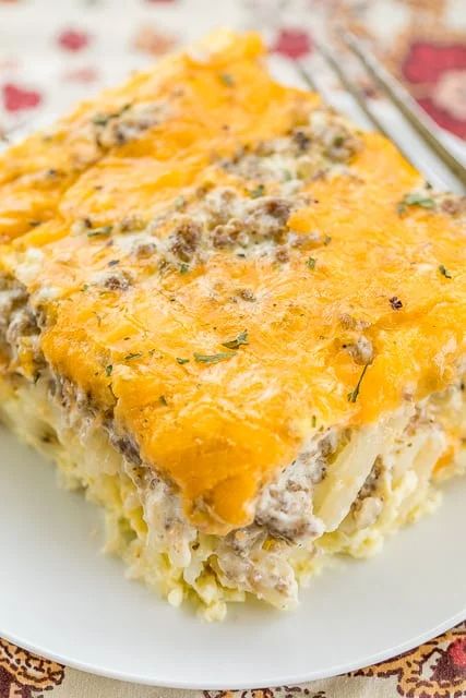 Sausage & Cream Cheese Hashbrown Breakfast Casserole - all of my favorite breakfast foods in one easy casserole! Frozen hashbrowns, sausage, cream cheese, eggs and cheddar cheese. Can make ahead of time and refrigerate or freeze for later. Can split between two pans and bake one and freeze one for later. This breakfast casserole is great for breakfast, lunch, great for brunch, potlucks, tailgating and any upcoming holiday breakfasts! SO GOOD! Sausage And Creamy Hashbrown Casserole, Cracked Out Breakfast Casserole, Creamy Breakfast Casserole, Sausage And Hashbrowns, Sausage Hashbrown Breakfast Casserole, Breakfast Lasagna, Hashbrown Breakfast, Sausage Cream Cheese, Cream Cheese Breakfast