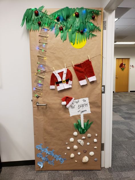 Palm Tree Christmas Door, Beach Santa Door Decoration, Santa At The Beach Door Decorations, Christmas School Door Decorating Ideas, Hawaiian Christmas Door Decoration, Tropical Christmas Door Decorations, Christmas Desk Decorating Contest, Beach Christmas Door Decorating Contest, Christmas Door Decorations Easy