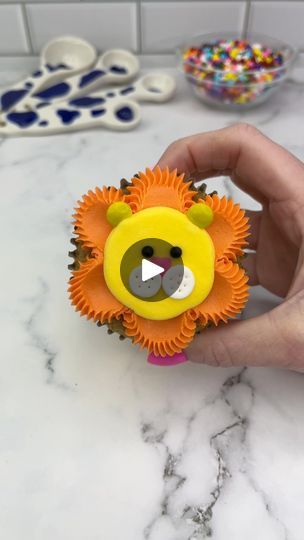 2.7M views · 41K reactions | 🦁🧡 Lion cupcakes 💛🦁 Guys, let’s make a cupcake zoo together 🧁 Starting with the king of the jungle 🦁🧁 Which animal should we add next? 🦁 Use an open star piping tip and orange buttercream to pipe dots around the edge of the cupcakes. 🦁 Using the pipe and swipe technique, spread the dots into the centre, using a small piping tip. 🦁 Use a round piping tip to add a large dollop of yellow buttercream to the middle of the cupcake. Smooth it with a spatula.🦁 Add two yellow mini M and Ms for ears and a heart sprinkle for the nose.🦁 Add two white fondant circles for the cheeks, using a toothpick to add dots. 🦁 Use two black sprinkles for his eyes. #cupcake #cupcakedecorating #animalcupcakes #cakedbyrach #tutorial | Caked By Rach | Jungle · I've Been In Lov Open Star Piping Tip, Star Piping Tip, Tiger Cupcakes, M And Ms, Lion Cupcakes, Specialty Cupcakes, Tea Time Party, White Fondant, Orange Buttercream