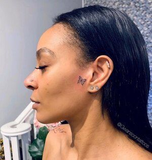 Butterfly on side of face Side Burn Tattoos For Women Face, Side Burn Tattoos For Women, Butterfly On Face, Butterfly Face Tattoo, Small Face Tattoos, Clavicle Tattoo, Face Tats, Face Tattoos For Women, Girl Neck Tattoos