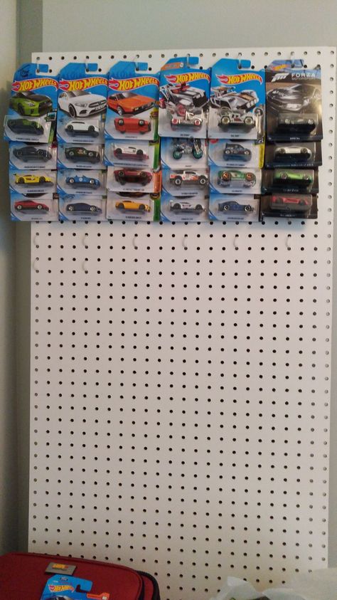 Creative and cheap DIY solution for a hot wheels display. Pegboard and dollar store zip ties. Expand as much as needed and hang anywhere you want. #hotwheels Hot Wheels Car Storage Ideas, How To Display Hot Wheels, How To Display Hot Wheels In Package, Hot Wheels Display Diy, Hot Wheel Car Display Ideas Diy, Hotwheel Display Idea, Hot Wheels Display In Package, Hot Wheel Organizer, Hot Wheels Organization Ideas