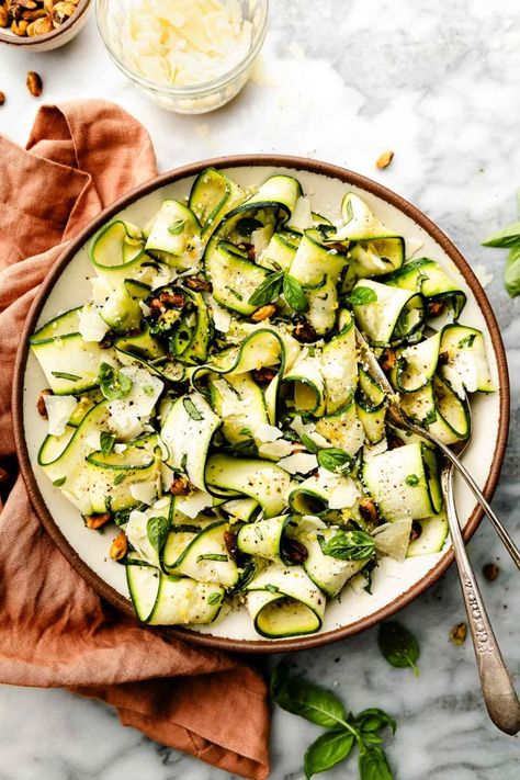 This easy Shaved Zucchini Salad is perfect for your summer squash harvest! By running a vegetable peeler along raw zucchini, it's easy to shave it into delicate zucchini ribbons that are the perfect base for a stunning seasonal salad. Simply toss with lemon, basil, garlic, pistachios, & parmesan cheese for a low-effort & show-stopping side dish. 7 ingredients, ready in 10 minutes! (Naturally meatless. Easily vegetarian & vegan.) #zucchinisalad #rawzucchinisalad #zucchinirecipes #saladrecipes Shaved Zucchini Salad, Raw Zucchini Salad, Zucchini Pasta Recipes, Grilled Lemon Chicken, Raw Zucchini, Parmesan Salad, Zucchini Ribbons, Food Experiments, Salad With Lemon