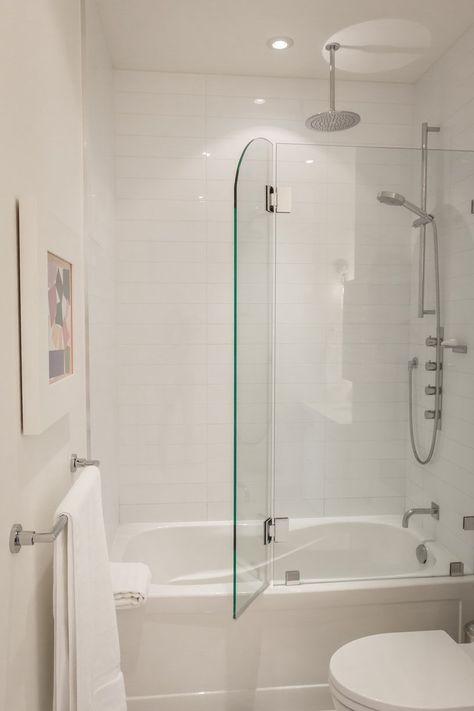 Greg  Rob's Sky Suite House Tour Toronto - white bathroom with glass door that opens for shower in bathtub Tub With Glass Door, Townhouse Remodel, Makeover Kamar Mandi, Shower And Bathtub, Walker House, Bathtub Shower Combo, Spare Bathroom, Bathroom Tub Shower, Bath Redo