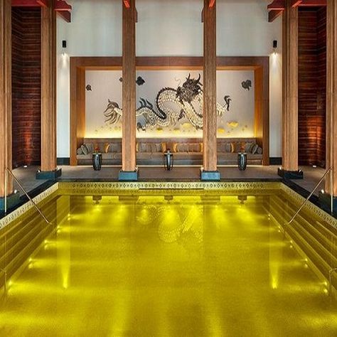 GOLD ENERGY POOL, TIBET - The St. Regis Hotel in Tibet is home to an amazing and lavish looking pool. The gold energy pool is a gold leaf tiled pool, that's also lined with gold leaf and allows the occupant to relax and rejuvenate in its heated, salt waters. Guests are pampered with foot massages, food and drinks all served pool-side, all adding to the allure of swimming in royal luxury. Amazing Swimming Pools, Hotel Swimming Pool, Indoor Pools, Luxury Swimming Pools, Mini Pool, Best Honeymoon Destinations, Cool Swimming Pools, Infinity Edge Pool, Most Luxurious Hotels