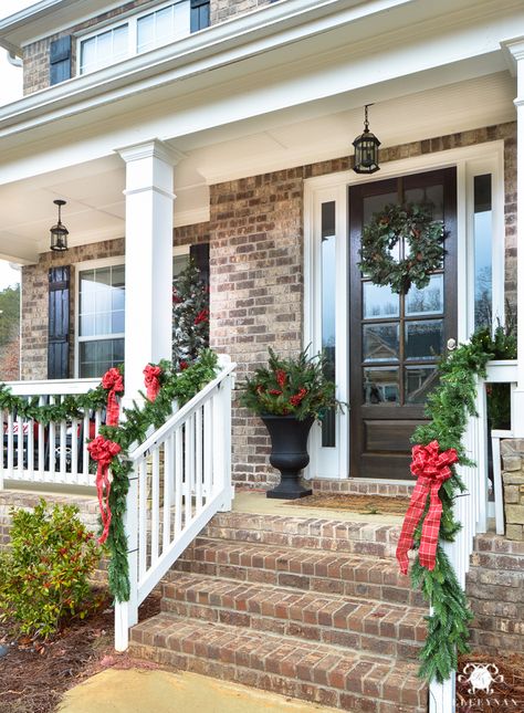 Kelley Nan: Holiday Home Showcase | 2016 Christmas Home Tour- Traditional and Classic Front Porch with Red Bows, Garland, and Urns of greenery on either side of front door Porch Garland, Christmas Front Porch, Christmas Front Doors, Front Steps, Christmas Porch Decor, Golden Gate Park, Christmas Living Rooms, Christmas Decorations For The Home, Outdoor Christmas Lights