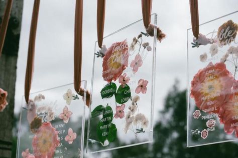 Not only does this pressed flower seating chart look like a beautiful art installation, it's also an incredibly unique idea — something your guests will not have seen before. Kick off the reception by displaying the seating chart at cocktail hour — it's guaranteed to get guests engaged and excited about the rest of the evening to come. Flower Seating Chart, Pressed Flower Wedding, Flower Wedding Decor, Flower Table Numbers, Watercolor Wedding Cake, Handmade Lanterns, Reception Backdrop, Wedding Table Plan, Wedding Venue Decorations