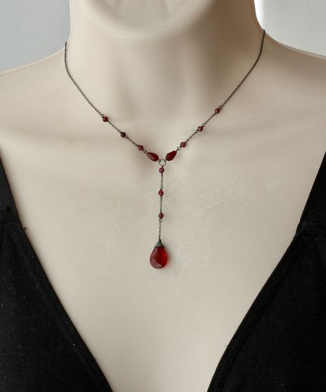 "PLEASE READ THE DESCRIPTION Vintage style, Victorian inspired Y delicate dainty Necklace with Faceted Dark Red Garnet Drop Bead 15 x 10 mm Faceted Garnet Stones 3 x 2 mm. Faceted garnet beads 7 x 4 mm The length of the hanging part is 2.5 inches long Sterling Silver oxidized chain. Closure has Garnet stones and oxidized Sterling Silver Spring Ring Clasp 6 mm. * * * * * * * * * * * * * * * * * * * * * * * * * * * * * * * * * * * * * * * * Your order will be wrapped and shipped in jewelry gift bo Antique Garnet Necklace, Victorian Inspired Jewelry, Black Dress Red Jewelry, Red Drop Necklace, Long Red Necklace, Beaded Drop Necklace, Y Necklace Silver, Goth Prom Accessories, Red Silver Jewelry