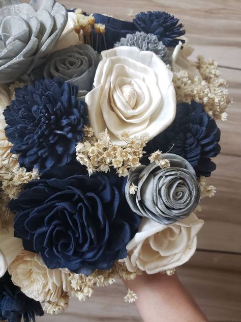 Sola wood flower wedding bouquet with navy blue and silver accent flowers. Bouquet has preserved greenery to give it that rustic look. Handle is wrapped with dark brown rope. Pictured is the large 12 inch bridal. Bouquet can also be made in small 8 inch or medium 10 inch. Can also add matching bridesmaid bouquets, corsages and boutonnieres per request. Bouquet can also be customized with different colors. Please message me for custom orders.Each flower is hand made and painted so a slight variat Navy Silver And White Wedding, Navy Blue And Silver Wedding Flowers, Dark Blue And Grey Wedding Theme, Navy Blue And Silver Wedding Reception, Midnight Blue And Champagne Wedding, Navy And Grey Wedding Decorations, Navy Blue And Grey Wedding Decorations, Navy Blue Quince Ramo, Dark Blue And Silver Wedding Theme