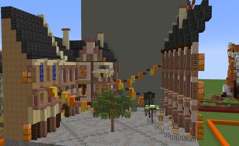 A Minecraft diorama of a street in Munich, Germany, celebrating Oktoberfest by draping orange and yellow bunting across the street. A diagonal café building on the right has chairs and tables set out beneath parasols, across the street from various other buildings. A small oak tree sits in the middle of the street. Minecraft Diorama, Cafe Minecraft, Minecraft Interior, Minecraft House Plans, Beer Hall, Chairs And Tables, Minecraft Plans, Tables Set, Minecraft House