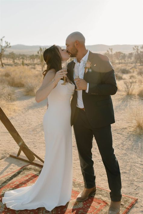 After the ceremony, we brought this bride and groom a glass of champagne to celebrate! They captured photos by the ceremony arch before adventuring through Joshua Tree national park. For more desert elopement inspiration, check out our blog! #joshuatree #brideandgroom #desertelopement Bride And Groom Champagne, Festival Style Wedding, Smallest Wedding Venue, Desert Elopement, Glass Of Champagne, Champagne Toast, Adventure Couple, Capture Photo, Ceremony Arch