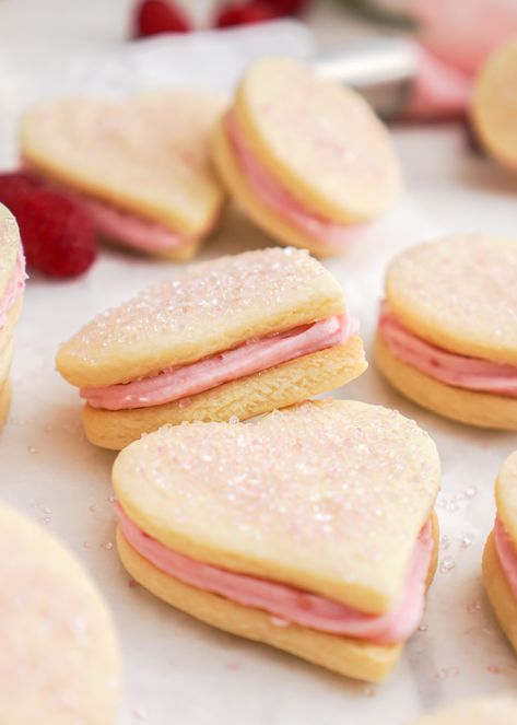 Spread some love with these cute heart shaped sandwich cookies. Each cookie features a soft buttery sugar cookie, filled with sweet raspberry buttercream icing and topped with pink sugar crystals for a crispy bite. They make the perfect cookie for Valentine's Day or any special occasion. Soft Sugar Cookie, Bulk Barn, Buttery Sugar Cookies, Valentines Recipes Desserts, Heart Sugar Cookie, Raspberry Buttercream, Buttercream Filling, Soft Sugar, Heart Shaped Cookies