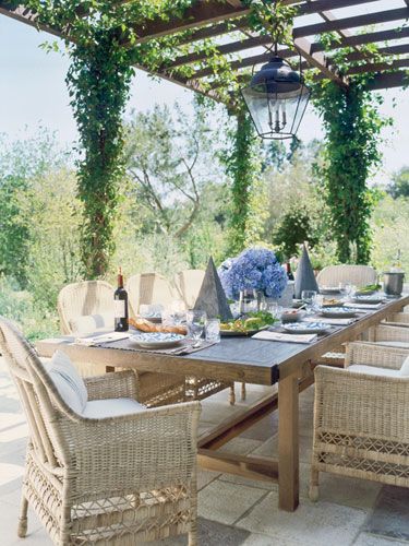 In the garden of a dreamy Southern California home, a remarkable long wooden table by Axel Vervoordt sits under a vine-covered pergola. Zinc sculptures add an architectural element to the table.  Tour the rest of the home.   - HouseBeautiful.com Patio Pergola, California Modern, Mediterranean Style Homes, Outdoor Dining Room, Covered Pergola, Casa Exterior, Outside Living, Pergola Plans, Pergola Patio