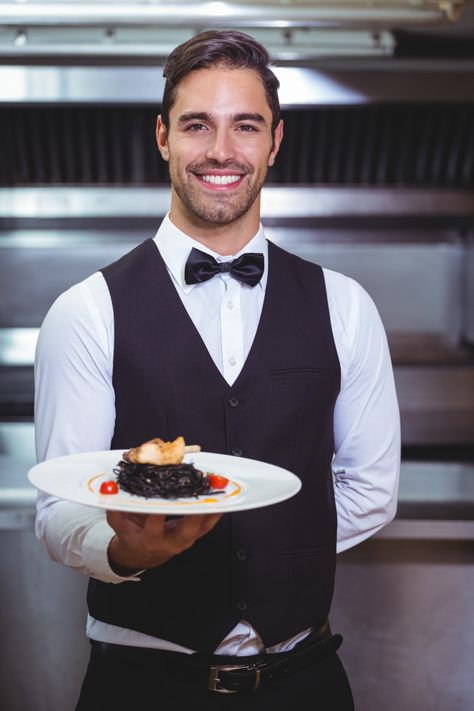 Download more Premium stock photos on Freepik Squid Ink Spaghetti, Holding A Plate, Employee Perks, Restaurant Photography, Typography Poster Design, Career Advancement, Chefs Kitchen, Photography Poses For Men, Serving Food