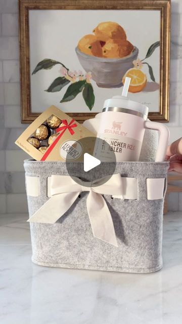 Maria Simonelli on Instagram: "Need a simple yet thoughtful last minute gift idea for her? I got you covered. Check out this adorable gift basket in a cute bow-front felt basket. It’s filled with a cozy knit throw, soft socks, a Stanley cup, and topped with delicious chocolates. 🎁✨ Perfect for any occasion! Want to create your own? Just comment ‘Shop’ and I’ll send you all the links. #giftideasforher #giftideas #giftbaskets #giftbasketsforalloccasions #lastminutegifts" Stanley Gift Ideas Filled, Stanley Cup Gift Basket Ideas, Stanley Gift Basket, Stanley Gift Ideas, Stanley Cup Gift Ideas Filled, Stanley Cup Gift Ideas, Cup Gift Ideas Filled, Cup Gift Ideas, Felt Basket