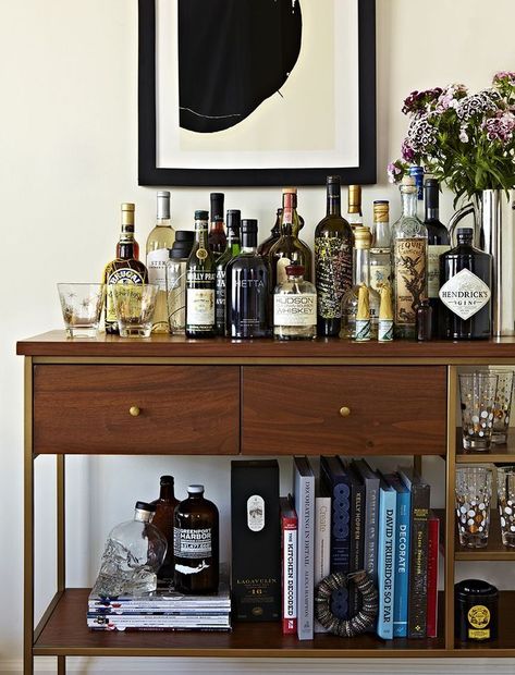 #refinery29  http://www.refinery29.com/tina-ramchandani-nyc-apartment-design#slide-6  What are your secrets to creating a gorgeous bar cart?"I love to style pieces so they look like part of the space, in addition to functioning as expected. A bar doesn't always have to look like a bar. This piece is actually an étagère we are using as a bar. I added books, plants, and objects to help this feel like a bookcase in addition to a bar cart. This also helped the bar ... Minimalist Bachelor Pad, Ikea Minimalist, Beds Minimalist, Nyc Apartment Design, Interiors Minimalist, Shelves Minimalist, Plants Minimalist, Bachelor Pad Decor, Architecture Minimalist