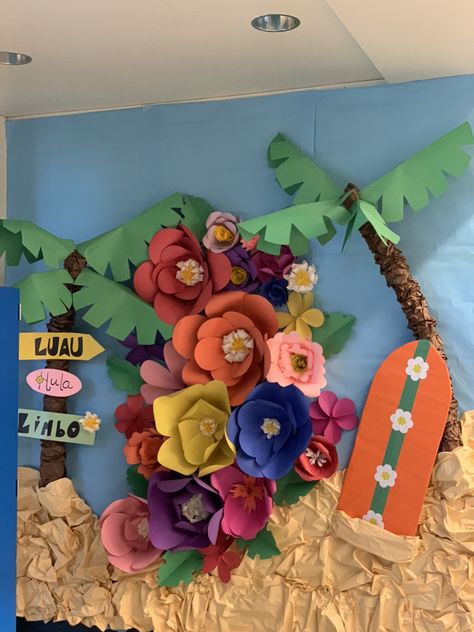 3D Pool noodle palm trees, cardboard surf board, and paper flowers for a photo backdrop. Ohana Bulletin Board Ideas, Hawaii Bulletin Board Ideas, Beach Theme Hallway School, Beach Hallway Decorations School, Moana Bulletin Board, Tropical Bulletin Board Ideas, Luau Backdrop Ideas, Hawaiian Bulletin Board Ideas, Lilo And Stitch Classroom Theme