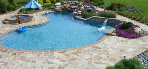 Flagstone Pool Decking with Boulder Waterfall Flagstone Pool Deck, Flagstone Pool, Belgian Block, Stone Backyard, Decking Options, Bluestone Pavers, Pool Decking, Stone Store, Travertine Pavers