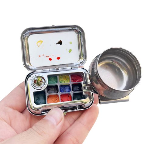 PRICES MAY VARY. 🎨【Travel Palette】-The watercolor box is made of high-quality mirror iron box, exquisite retro nostalgic pattern, mini and exquisite. The watercolor box is sleek and compact, yet sturdy and durable. This travel palette is a fun and unique travel palette! It’s great for air painting or urban sketching. 🎨【Mini Portable】-The little chubby watercolor box is very mini and exquisite, with a mini and round appearance, it is very convenient to put it in your pocket or bag and carry it Portable Painting Kit, Watercolor Paints To Buy, Travel Art Kit Diy, Travel Painting Kit, Paint Equipment, Square Sketchbook, Painting Equipment, Travel Palette, Pochade Box