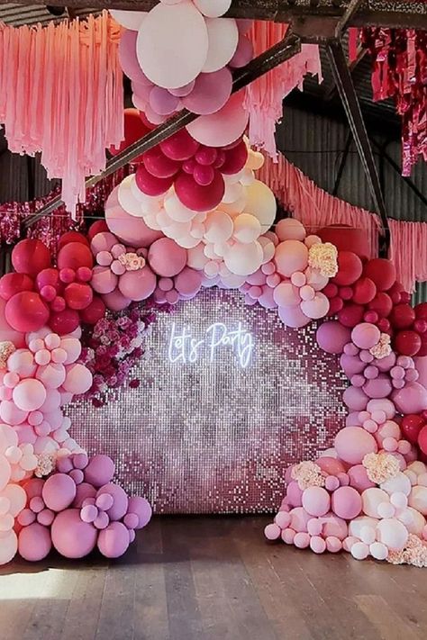 Bring glitz & glam to the party decor by setting up a fabulous backdrop and make your guests WOW. Exude a rejuvenating vibe by designing a ritzy backdrop using blush sequin wall with “Let’s Party” light sign and add extra pizzazz by pepping it with a fuchsia, pink, & blush balloon garland and insert blush wisteria vines for a striking display. Create a vibrant ceiling decor by hanging fuchsia fringe foil curtains along with blush paper streamers and make your party look aesthetically attractive. Blush Balloon Garland, Unique Event Decor, Girls Birthday Party Games, Wisteria Vines, Pink Event, Butterfly Centerpieces, Balloons Galore, Sequin Wall, Pink Birthday Party