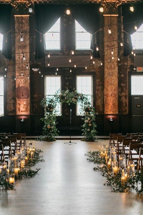 rustic loft wedding aisle decoration Moody Indoor Wedding Ceremony, Wedding Alter Floor Decor, Dark Wedding Ceremony Aesthetic, Ceremony Venue Ideas, Indoor Alter Ideas, Wedding In Old Building, Urban Wedding Ceremony, Smilax Arch, Church Wedding Venue Ideas