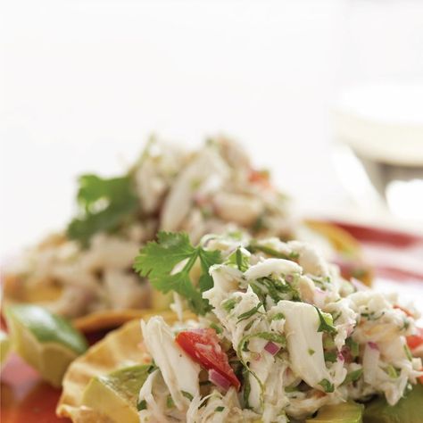 I often wonder if tostadas—crisp tortillas mounded with your choice of topping—were the first version of modern-day nachos. If so, these would definitely be called "supreme." Crunchy tortillas are layered with slices of creamy avocado and topped with a zesty crab salad to make the perfect appetizer. Crab Tostadas, Tostadas Recipe, Tostada Recipes, Quesadillas, Mexican Dishes, Fajitas, Tortillas, Burritos, Nachos