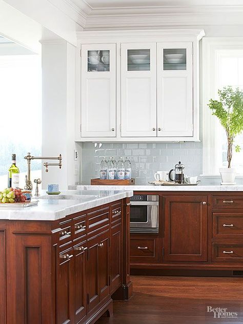 Dark walnut base cabinetry combats marks from heavy use, but upper cabinets with a white-painted finish keep this kitchen light and bright. The custom wood cabinets feature classic paneling and are grounded by stained oak floors. Natural Wood Kitchen Cabinets, Cherry Wood Kitchen Cabinets, Walnut Kitchen Cabinets, White Upper Cabinets, Cherry Wood Kitchens, Upper Kitchen Cabinets, Clean Kitchen Cabinets, Kitchen Luxury, Walnut Kitchen