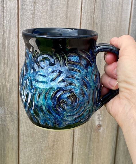 "Please note my turnaround time is 4-6 weeks. Please contact me if you need an item sooner and I can let you know when my next kiln firing will be. All pieces unless otherwise noted are made to order Made to order beautiful hand carved and sculpted pottery coffee mug holds approximately 14 - 16 oz. This glaze combination is called dragon. This listing is for ONE coffee mug. Each piece if pottery is shaped by hand out of high fire clay, then carved by hand, glazed, and fired to cone 6 which is 22 Whimsical Pottery Mugs, Coffee Mug Handmade, Cool Mug Designs Ceramics, Ceramic Wheel Throwing, Homemade Ceramic Mugs, Pottery Glaze Designs, Glaze Designs Ceramics, Ceramic Mug Shapes, Pottery Designs Carving