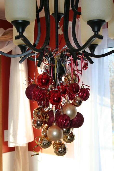 Christmas decorations-bulbs from chandelier Christmas Decor Ideas For Chandelier, Decorating A Chandelier For Christmas, Christmas Chandelier Decorations, Chandelier Christmas Decor, Chandelier Ornaments, Make A Chandelier, Christmas Chandelier Decor, Christmas Chandeliers, Christmas Chandelier