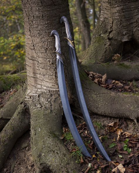 The Curved Elven Sword is the quintessential weapon for an elven ranger, warrior or aristocrat. The iconic curved blade hints toward a sophisticated and intricate philosophy, supported by a distinct handle with meandering ornamentation mimicking an exotic blend of precious metals and white wood. Perhaps these swords were crafted aeons ago from magically imbued alloys? Only your elven character would know! Curved Blade Swords, Elven Swords, Ethereal Universe, Prop Concept, Elven King, Curved Swords, Fantasy Blade, Props Concept, Types Of Swords