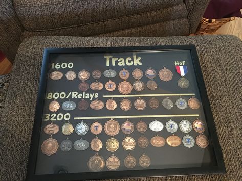 High school track medals display  Materials used: Shadow box Foam back black board glue dots stickers/letters (I cut mine on my Cricut machine) Track Medals, Sports Shadow Boxes, Graduation Display, Photo Organization Storage, Sports Medal Display, Medals Display, High School Track, Old Trophies, Track Senior Pictures