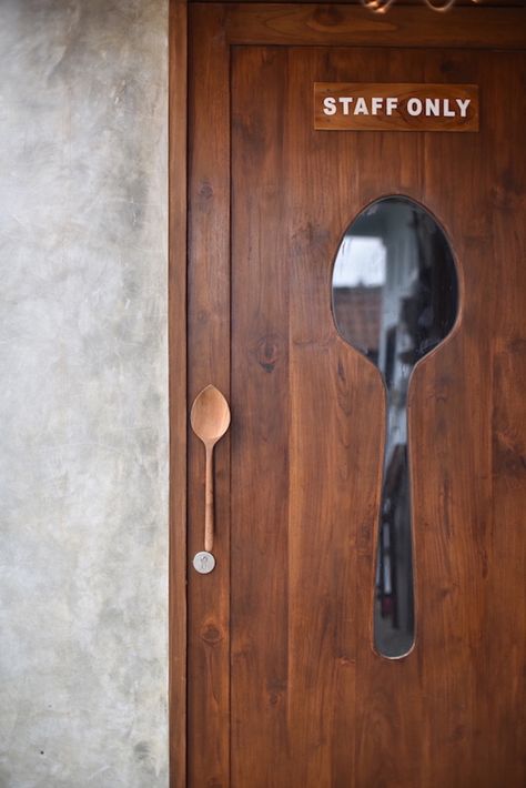 this cafe in bali, indonesia plays with spoon Kitchen Door Restaurant, Cafe Door Design, Diy Restaurant Decor, Resturant Ideas Design Interiors, Restaurant Kitchen Door, Cafe Theme Ideas, Cafe Decoration Ideas, Restaurant Wall Design Ideas, Cafe Wall Design