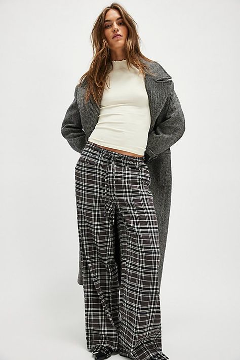 A perfectly plaid version of our Hudson Canyon Stripe Pants, this slouchy pair is featured in a high-rise fit and wide-leg style with a drawstring waistband. **Fit:** High-rise; wide, full-length legs **Features:** Soft cotton fabrication with wide plaid print throughout, adjustable drawstring waistband, pockets for hands, back-pocket detail **Why We ❤ It:** These billowy pants pair perfectly with your favorite tank and strappy sandals. | Hudson Canyon Plaid Pants by Free People in Black, Size: Plaid Cargo Pants Outfit, Casual Plaid Pants Outfit, Plaid Pajama Pants Outfits, Plaid Pants Outfit Winter, Plaid Cargo Pants, Wide Leg Plaid Pants, Pajama Pants Outfit, Thrift List, Plaid Pants Outfit