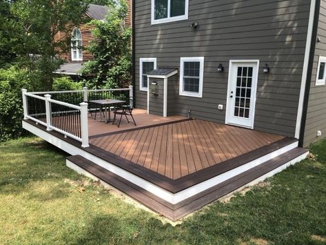 Arlington deck in Trex Transcends in Tiki Torch with Lava Rock border. Ground Level Trex Deck, Trex Deck With Pergola, Deck Border, Simple Back Deck Ideas, Deck Border Ideas, Trek Deck Ideas, Ground Level Deck Ideas, Deck Patio Combo Ideas, Trex Deck Ideas Color Schemes