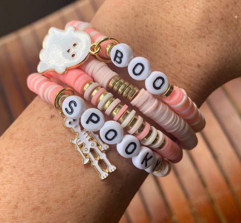 This super trendy pink Halloween themed bracelet stack makes the perfect accessory for the Spooky season 👻  Light pink & cream bracelet are adorned with gold accents and two sweet ghoul charms. Each stack comes with a set of 4 (Four) bracelet.  Bracelets are made with high quality string which gives them great durability, thus allowing for stretching and readjusting.  Handmade in the USA Pastel Halloween Bracelets, Halloween Friendship Bracelet, Colorful Bead Bracelets, Halloween Bracelet, Bracelet Craft Diy, Accessories Cute, Bracelets Design, Trendy Halloween, Pink Halloween