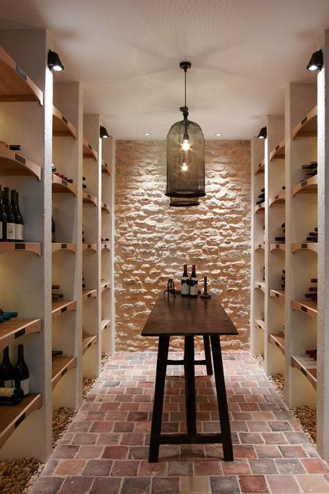 Hanging lamps with netted shades give the wine cellar a charasmatic light.  [i][b]Like this? You might also like [link url="http://www.houseandgarden.co.uk/interiors/real-homes/chateau-de-sully-burgundy"]A Renaissance Château With a Fairytale Story[/link] [/b][/i] Cellar Inspiration, Wine Cellar Inspiration, Wine Cellar Ideas, Cellar Ideas, Wine Cellar Basement, Wine Closet, Wine Cave, Home Wine Cellars, Wine Cellar Design