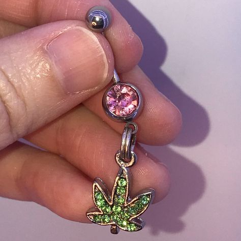 These Are 316-L Stainless Steel Belly Ring With A Dangle Of A Pot Leaf Design. The Ring In The Middle Is A Split Or Spring Ring. It's Designed This Way So Your Charm Stays On Your Belly Ring. If You Want A Different Color Belly Ring Let Me Know I Can Change Them Out. This Is A Standard 14 Gauge Belly Ring. The Top Gem Changes From One Belly Ring To Another But The Bottom Stays The Same. It Is A Peridot Green Rhinestone Pot Leaf That Is Made Out Of Pewter. #Handmade #Potleaf #Rhinestone #Bellyrin Cute Belly Rings, Bellybutton Piercings, Belly Button Piercing Jewelry, Belly Piercing Jewelry, Dangle Belly Rings, Cute Piercings, Belly Jewelry, Body Jewelry Piercing, Peridot Green