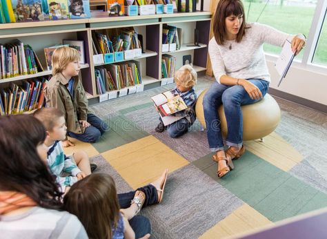 Teacher Reading Book To Children In Library. Young teacher reading book to child , #Ad, #Children, #Library, #Young, #Teacher, #Reading #ad Backpack Photoshoot, Child Reading A Book, Reading To Children, Book Shoot, Children Library, Fun Phonics Activities, Book Buddies, Children Reading, Librarian Chic