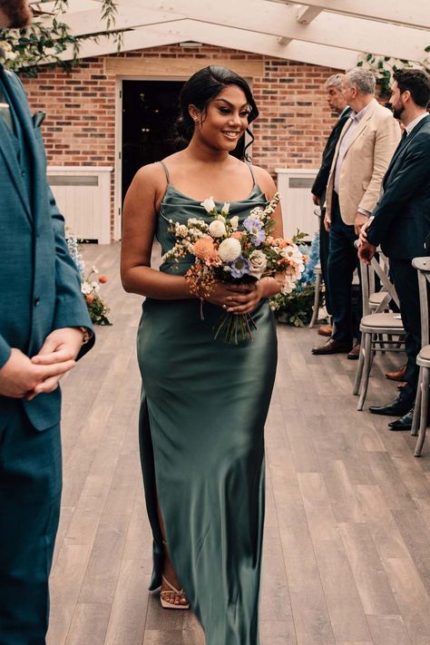 Bridesmaid in a green satin bridesmaid dress walking down the aisle holding a colourful wildflower wedding bouquet | Abbie Sizer Photography Watteau Train Wedding Dress, Green Satin Bridesmaid, Green Satin Bridesmaid Dresses, Watteau Train, Green Bridesmaid Dress, Wildflower Wedding Bouquet, Train Wedding Dress, Vegan Wedding, Wedding Dress Train