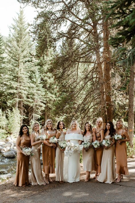 Bridesmaids dressed in silk neutral dresses take their photos be the river before a real Donovan Pavilion wedding ceremony just outside of Vail, Colorado. Cream Brown Wedding Theme, Mountain Wedding Party Colors, Bridesmaid Dresses Muted Colors, Tan Mix Match Bridesmaid Dresses, Mismatched Brown Bridesmaid Dresses, Two Color Bridesmaid Dresses, Bridesmaid Dresses Mountain Wedding, Beach Wedding Inspo Bridesmaid Dresses, Earthy Neutral Wedding