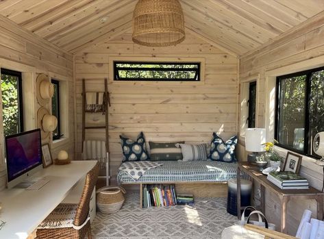 The image shows a gorgeous office/studio shed with amazing pine interior and black contrasting windows.