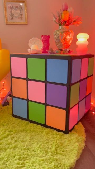 @jack.brickhouse on Instagram: "Here’s a fun commission I did for @berry.freshh ! A Rubik’s cube side table/storage chest cut out on the CNC. I like to think of it as a collab cause Olive painted the squares and shot the reel. More shots of the storage compartment coming 🌞 #furnituredesign #shapeoko #rubikscube #asheville #pastel #cheeseburgerinparadise #friendsdontlie #artfurniture #brickhouse #custom #rainbowaesthetic #queerfashion #colorfulhomedecor #handmade #cnc #kitsch #ashevillemaker #co Cube Bedside Table, Cool Bedside Tables, Funky Coffee Tables, Unusual Bedside Tables, Cube Decor, Side Table Storage, Cube Coffee Table, Quirky Furniture, Cube Furniture