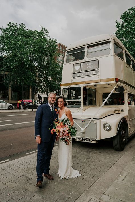 Cream Vintage Bus For Wedding Transport | By Joasis Photography | Wedding Bus | Wedding Bouquet | Wedding Decor | City Wedding | London Wedding | Bright Colour Flowers | Charlie Brear Dress | Bride Dress | Wedding Dress | Bridal Gown Petal Wedding Cake, Plunging Neckline Wedding Dress, Neckline Wedding Dress, Wedding Transport, Protea Bouquet, Wedding London, Vintage Bus, Vintage Car Wedding, Colour Flowers