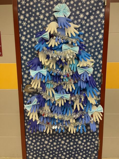 My husband is a school nurse. For his clinic door, he made a tree from surgical gloves and masks and plans to add band-aid boxes for gifts. :) Christmas Door Decorations Medical, Christmas Door Decorating Contest Medical Office, School Nurse Christmas Door, School Nurse Door Decoration, Nurse Door Decorations, Medical Crafts, School Nurse Door, Nurse Christmas Tree, Boxes For Gifts